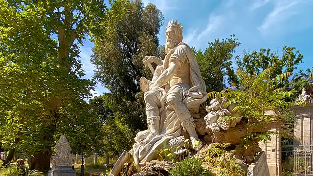 Springbrunnen mit der Statue des römischen Schutzgeistes im Park <strong><em>Villa Giulia</em></strong> von Palermo.